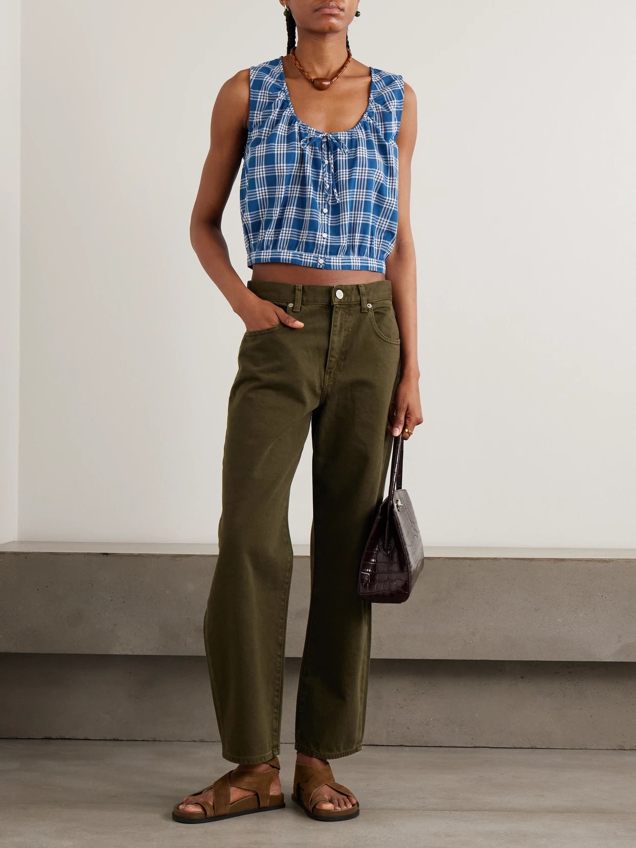 Image of a model wearing Tops. Product name - Theo Cropped Checked Organic Cotton Top in Blue colour by brand - DÔEN