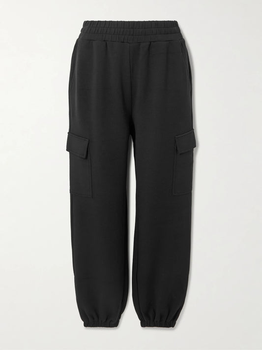 Image of a model wearing Pants. Product name - The Cargo Doublesoft Track Pants in Black colour by brand - Varley