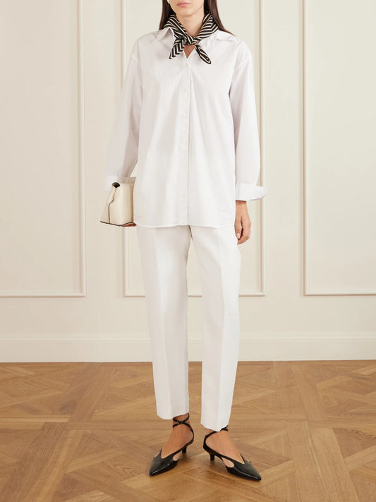 Image of a model wearing Pants. Product name - Wool And Silk-blend Straight-leg Pants in Ecru colour by brand - TOTEME