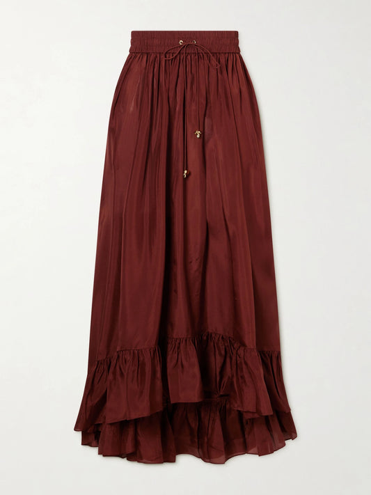 Image of a model wearing Skirts. Product name - Aster Ruffled Silk Maxi Skirt in Brick colour by brand - Zimmermann