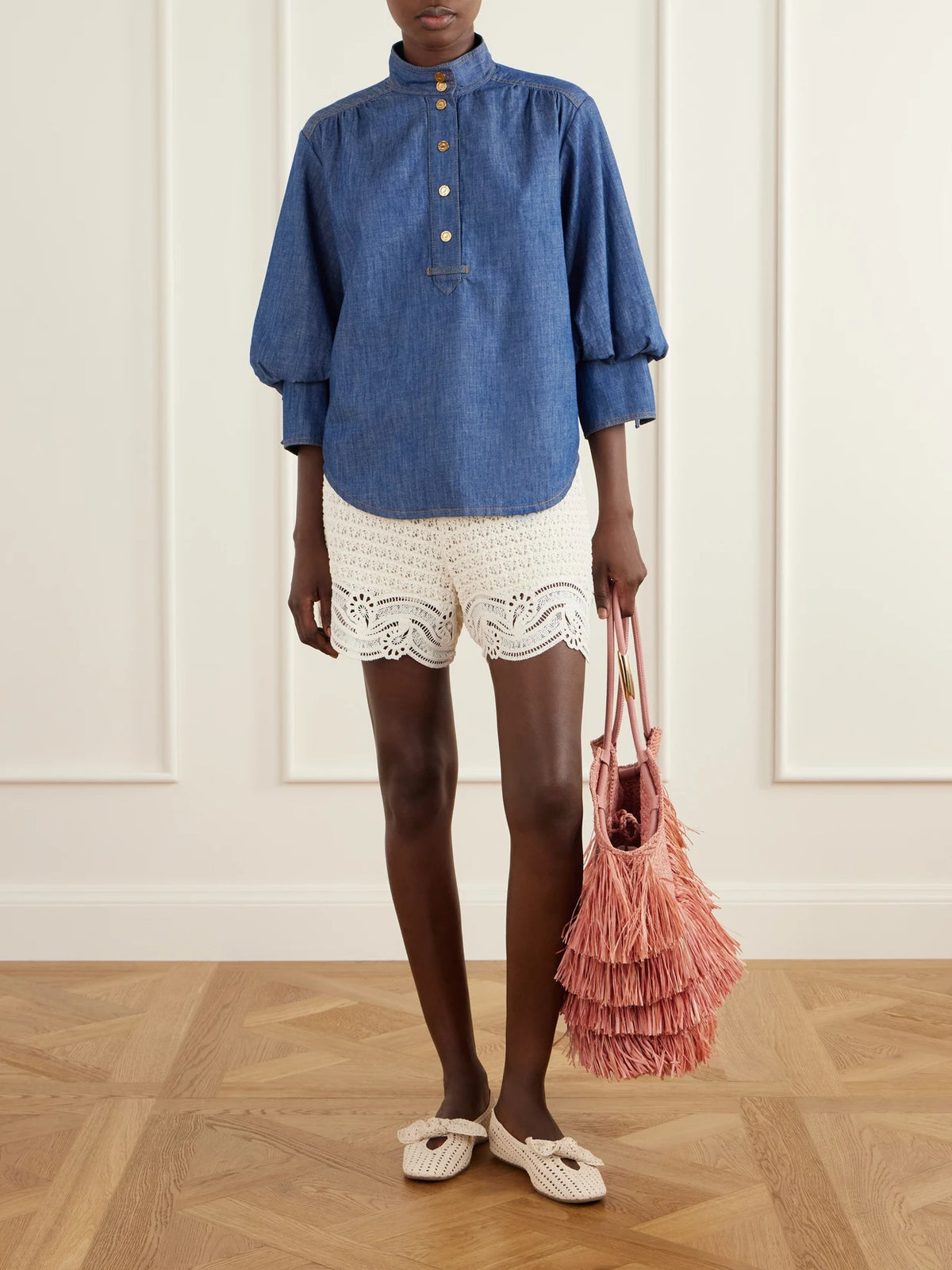Image of a model wearing Tops. Product name - Echo Denim Shirt in Blue colour by brand - Zimmermann