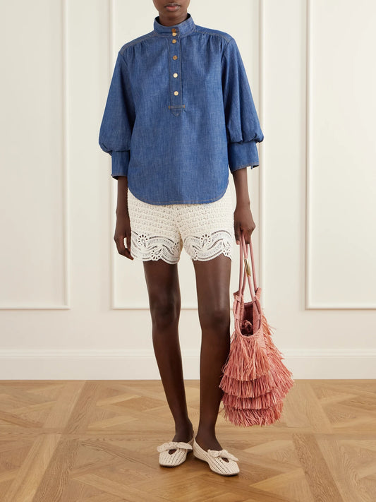 Image of a model wearing Tops. Product name - Echo Denim Shirt in Blue colour by brand - Zimmermann