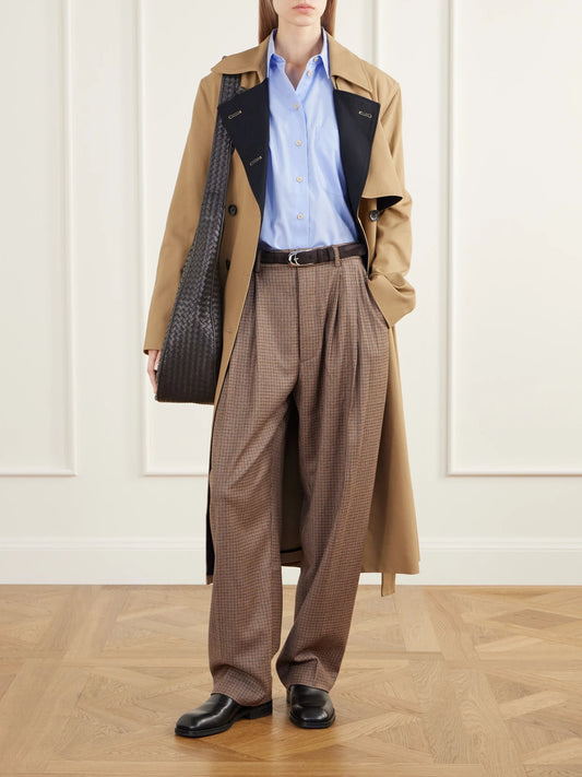 Image of a model wearing Pants. Product name - The Tapered Pleated Houndstooth Stretch Wool-blend Pants in Brown colour by brand - Jamie Haller