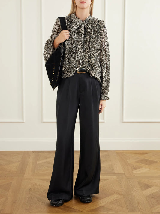 Image of a model wearing Tops. Product name - Charlize Tie-detailed Ruffled Animal-print Chiffon Blouse in Black colour by brand - Sea
