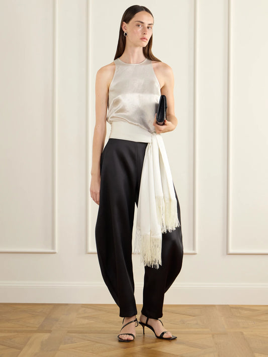 Image of a model wearing Pants. Product name - Posey Satin Barrel-leg Pants in Black colour by brand - RÓHE