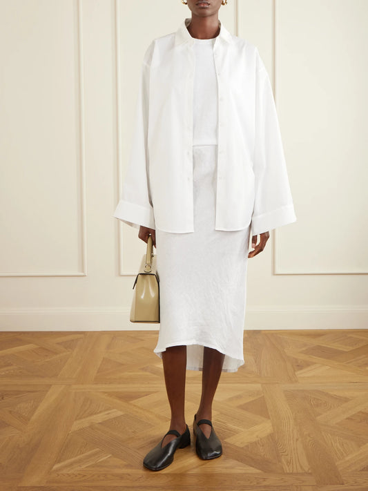 Image of a model wearing Skirts. Product name - Linen-canvas Midi Skirt in White colour by brand - James Perse