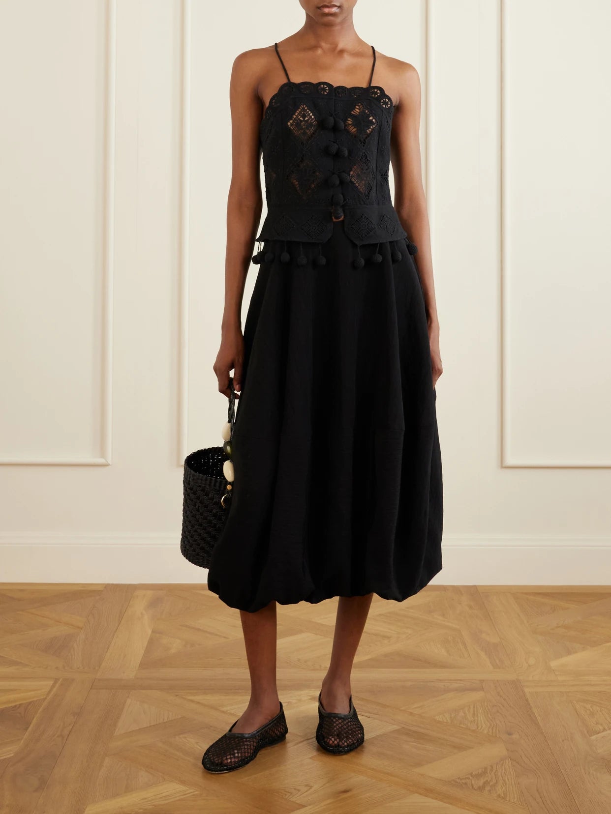 Image of a model wearing Skirts. Product name - Lisette Shell Midi Skirt in Black colour by brand - Sea