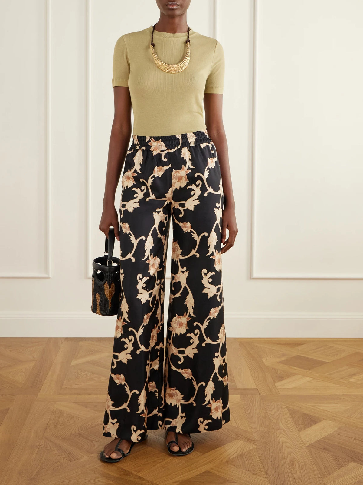 Image of a model wearing Pants. Product name - Palazzo Floral-print Silk-twill Wide-leg Pants in Black colour by brand - La DoubleJ
