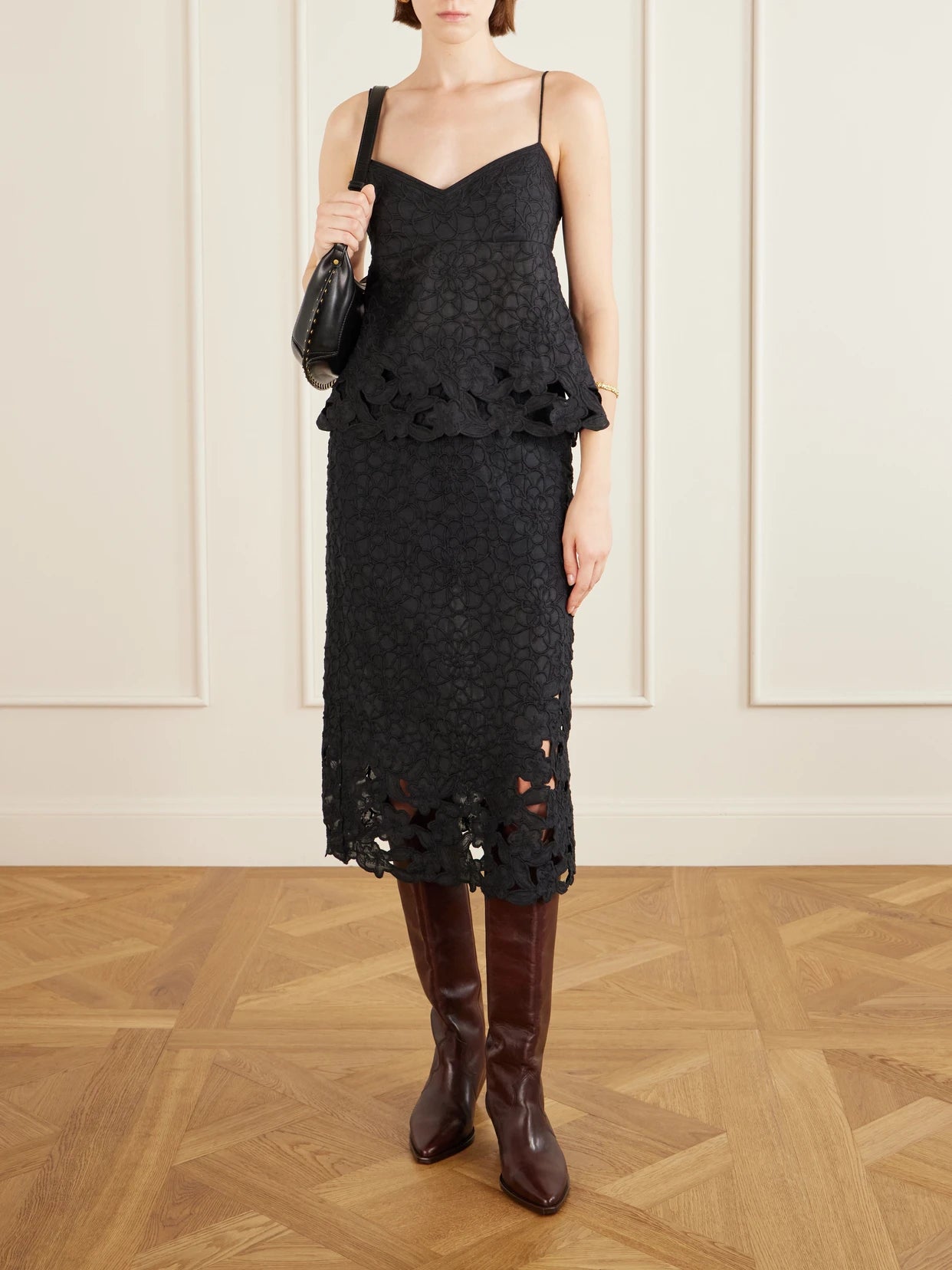 Image of a model wearing Skirts. Product name - Reysha Embroidered Ramie Midi Skirt in Black colour by brand - ISABEL MARANT
