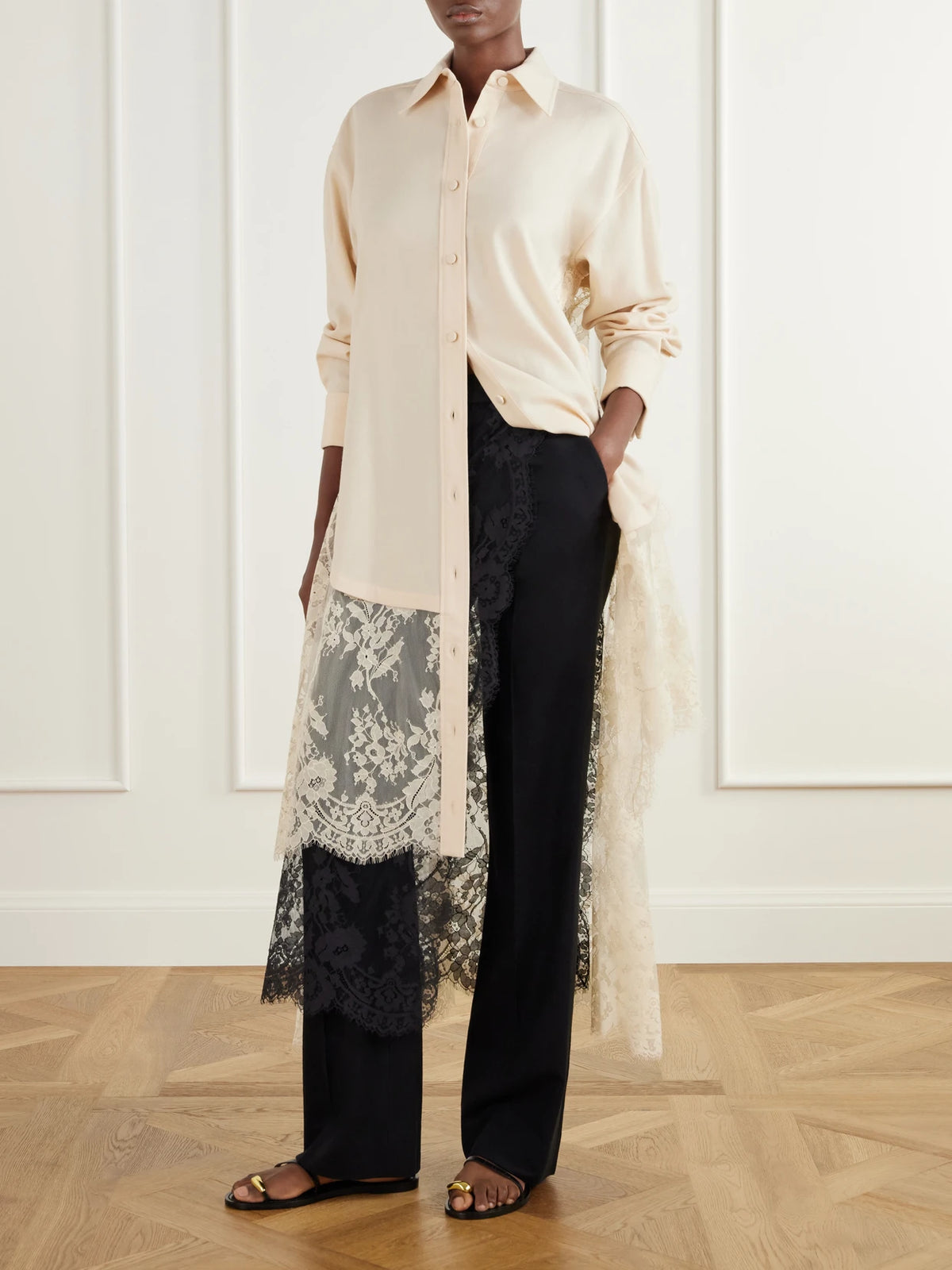 Image of a model wearing Pants. Product name - Valiant Layered Lace-trimmed Stretch-linen Twill Straight-leg Pants in Black colour by brand - Zimmermann