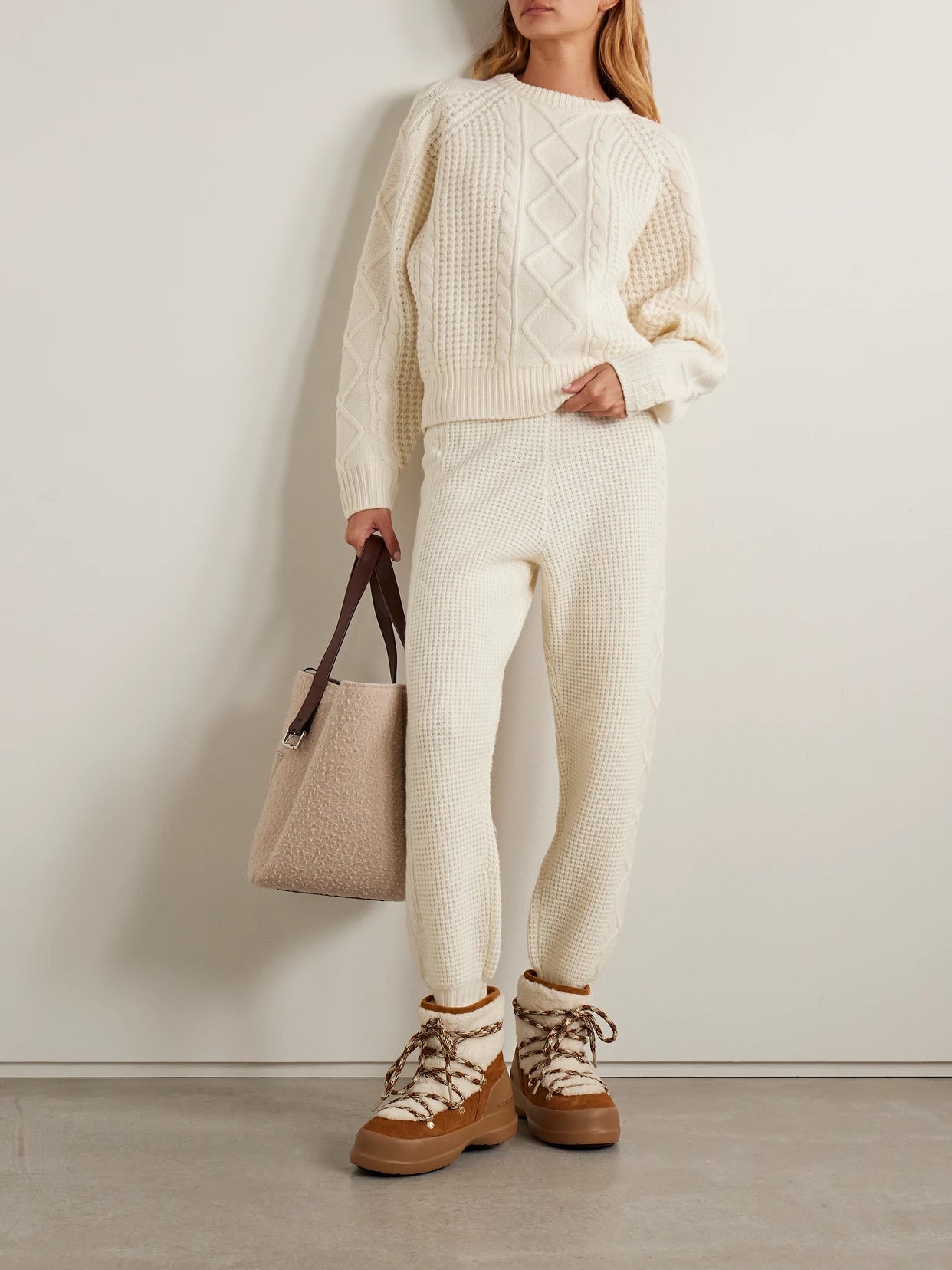 Image of a model wearing Pants. Product name - Crystal Cable-knit Wool Tapered Pants in Cream colour by brand - Perfect Moment