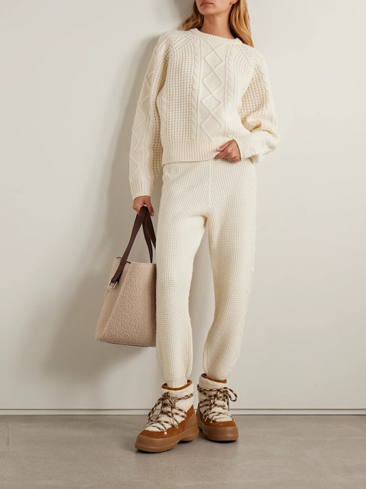 Image of a model wearing Pants. Product name - Crystal Cable-knit Wool Tapered Pants in Cream colour by brand - Perfect Moment