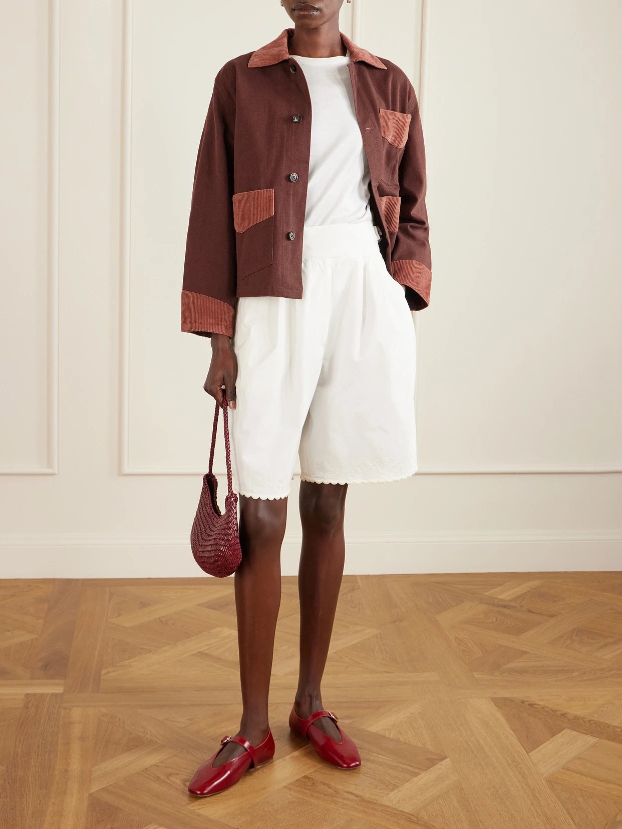 Image of a model wearing Shorts. Product name - Closerie Belted Scalloped Embroidered Cotton-poplin Shorts in Ecru colour by brand - BODE