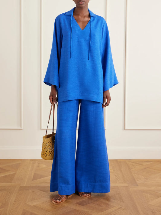 Image of a model wearing Outerwear. Product name - Tie-detailed Woven Tunic in Blue colour by brand - Lisa Marie Fernandez