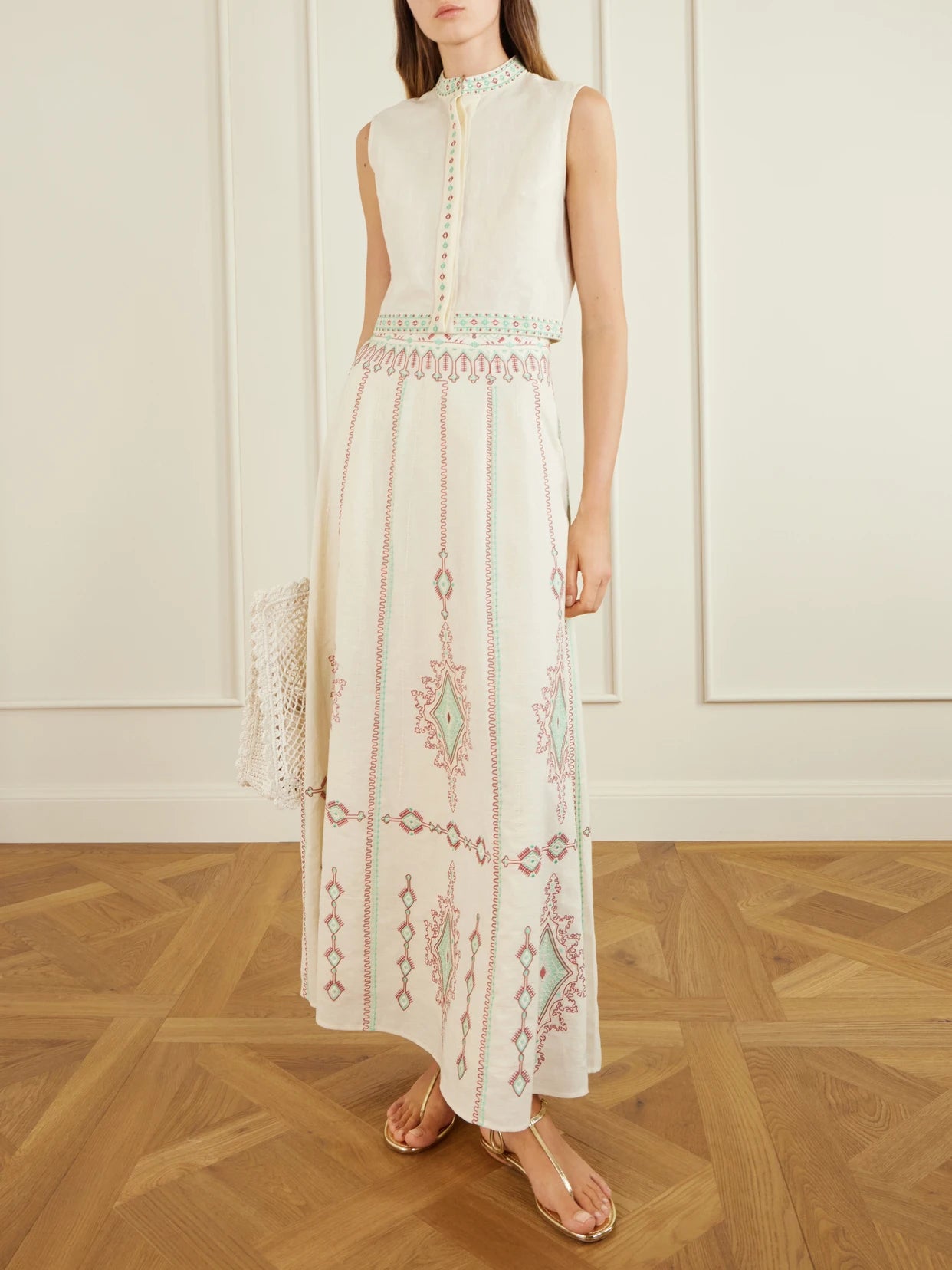 Image of a model wearing Skirts. Product name - Camille Embroidered Linen And Cotton-blend Midi Skirt in Cream colour by brand - Emporio Sirenuse