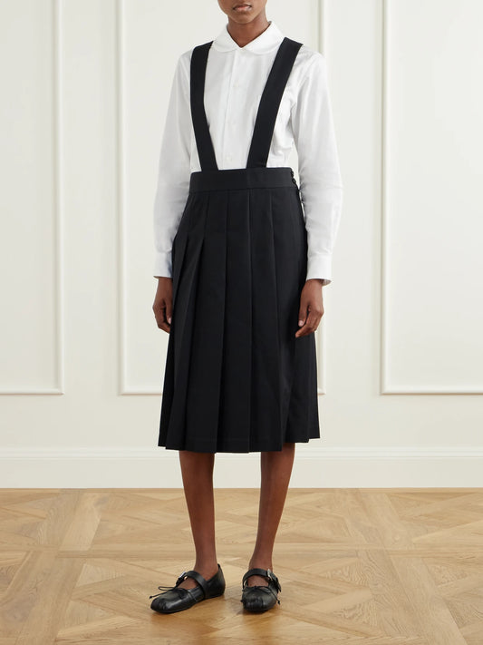 Image of a model wearing Skirts. Product name - Pinafore Wool Midi Skirt in Black colour by brand - Comme des Garçons GIRL