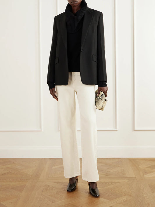 Image of a model wearing Outerwear. Product name - Funnel-neck Brushed Wool Sweater in Black colour by brand - TOTEME