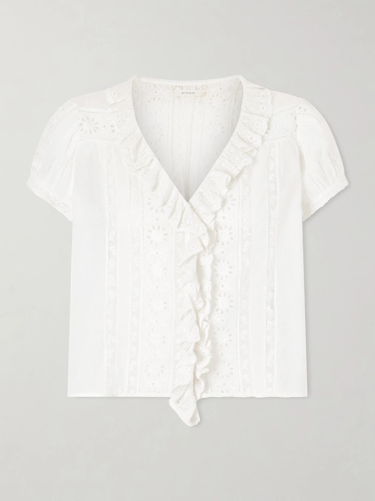 Image of a model wearing Tops. Product name - Clairette Cropped Ruffled Lace-trimmed Organic Cotton-voile Top in White colour by brand - DÔEN