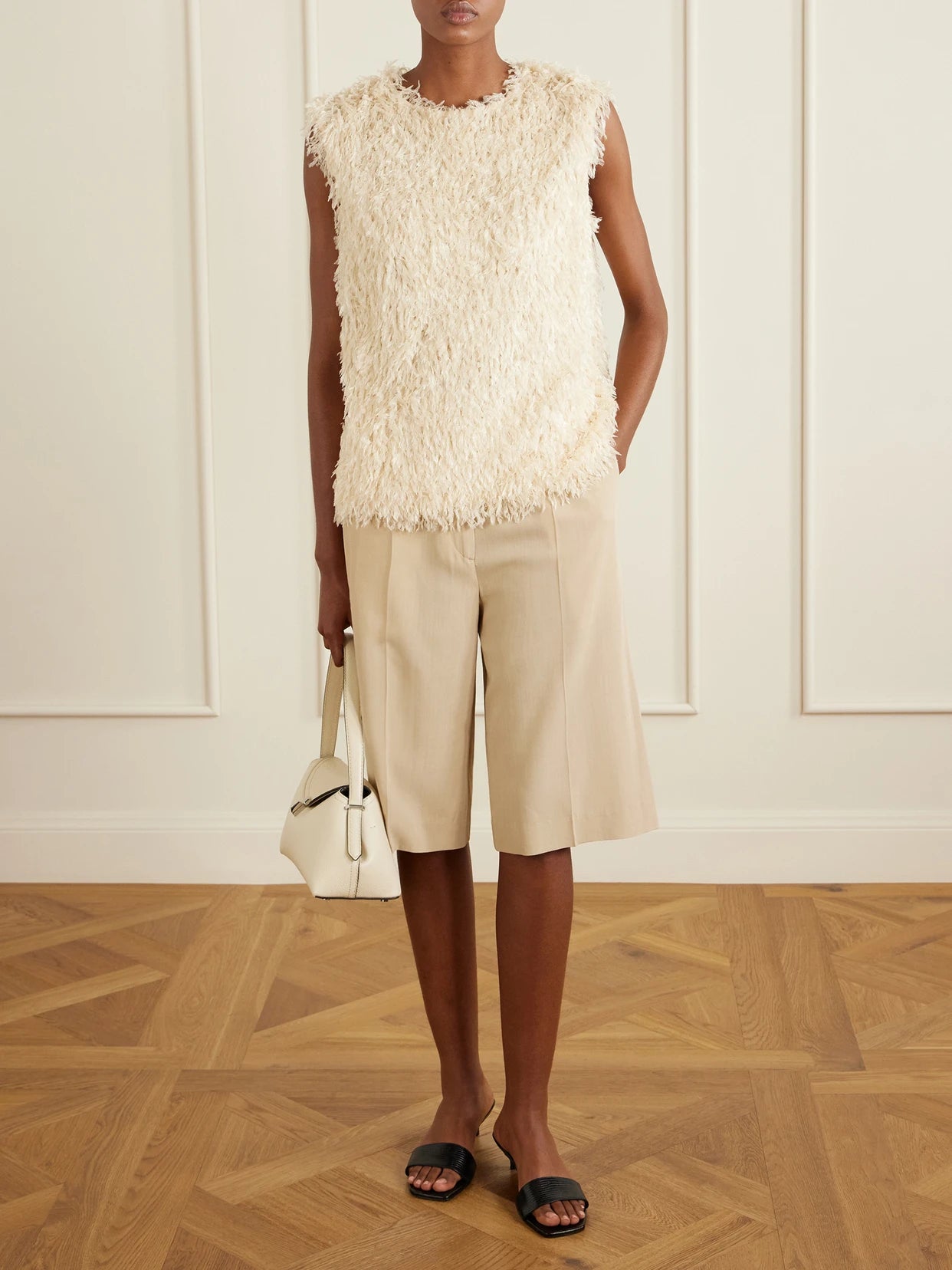 Image of a model wearing Tops. Product name - Fleece Top in Off-white colour by brand - TOTEME