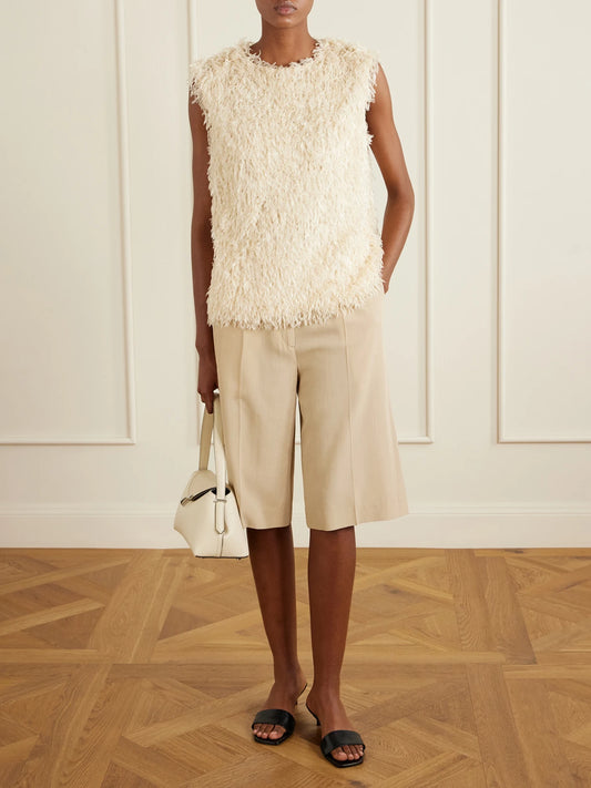 Image of a model wearing Tops. Product name - Fleece Top in Off-white colour by brand - TOTEME