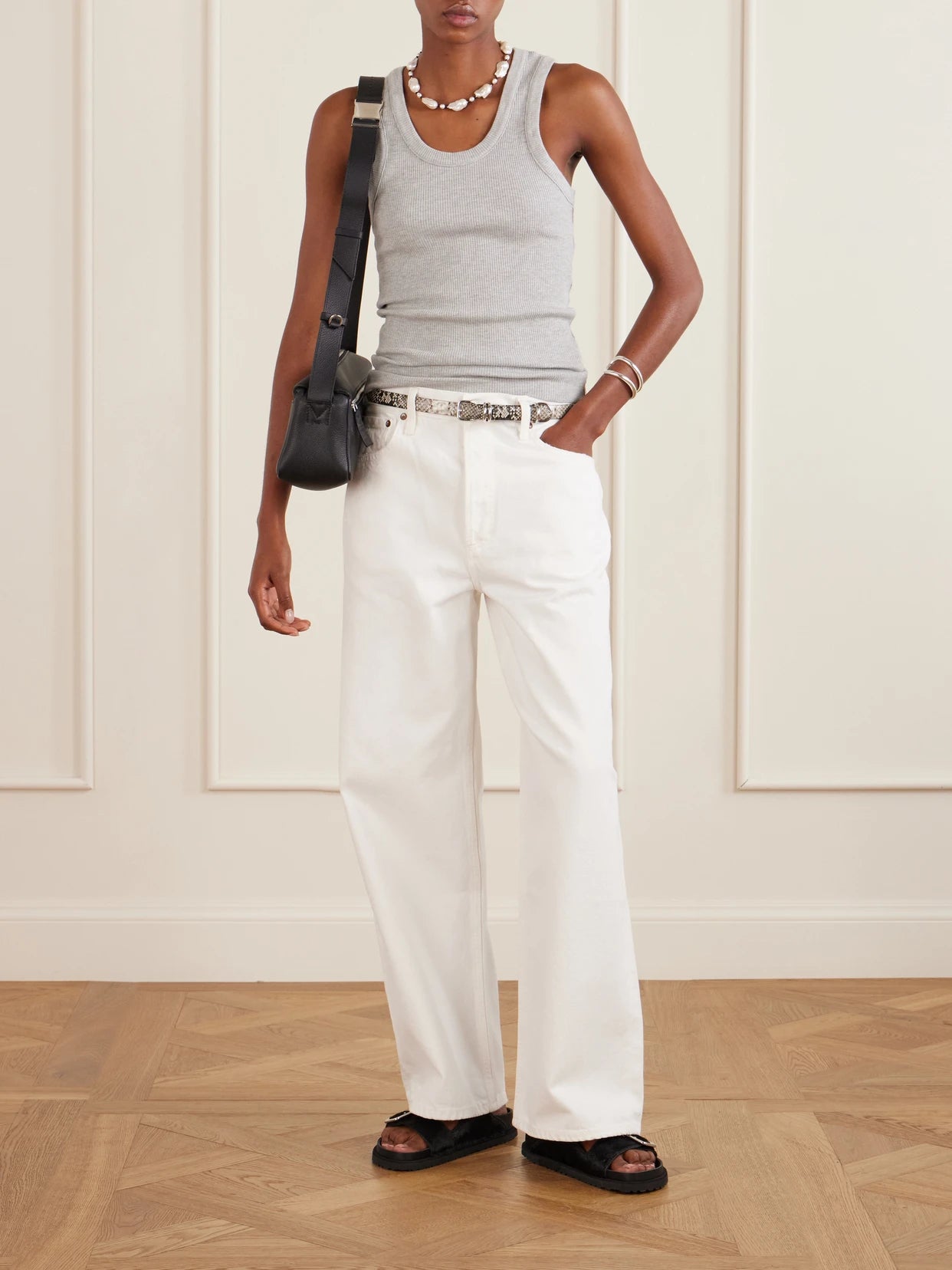 Image of a model wearing Tops. Product name - Poppy Ribbed Stretch Organic Cotton And Tencel Lyocell-blend Jersey Tank in Gray colour by brand - AGOLDE