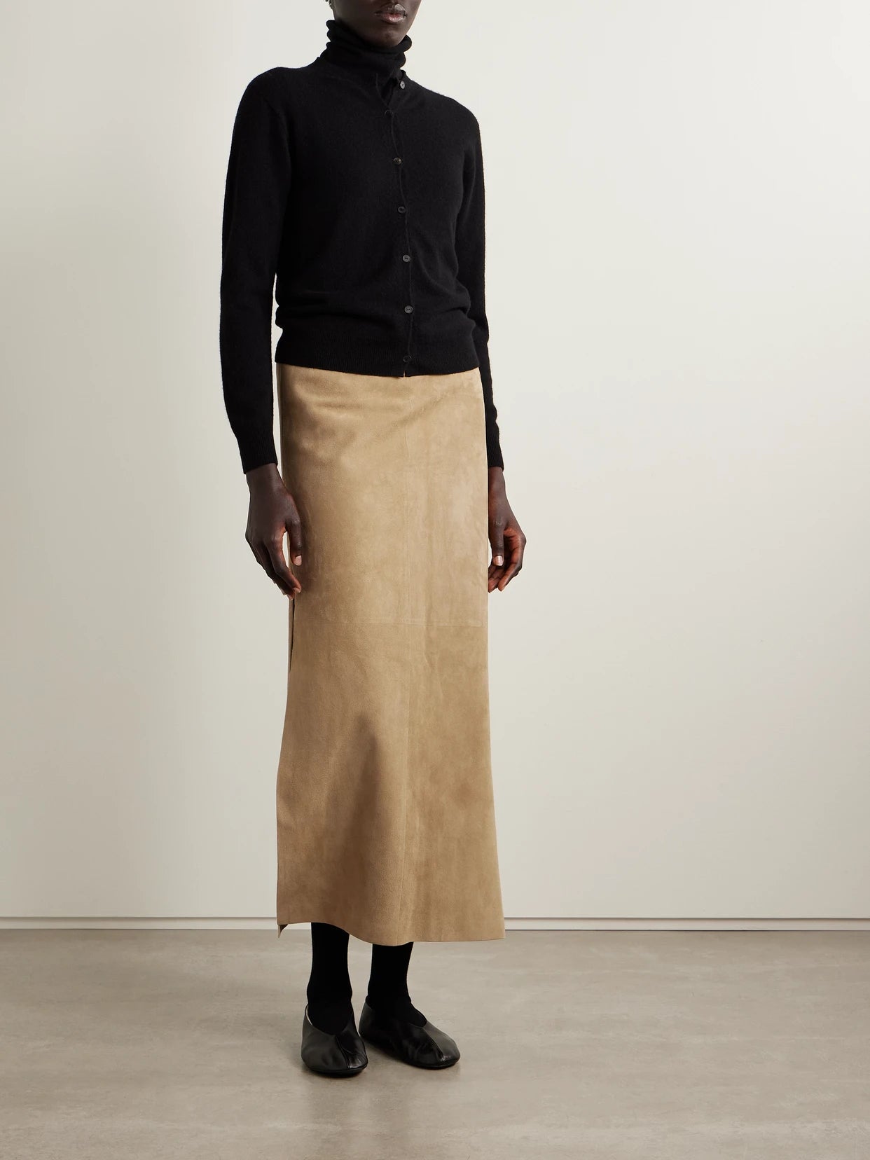 Image of a model wearing Skirts. Product name - Danas Paneled Suede Midi Skirt in Beige colour by brand - The Row