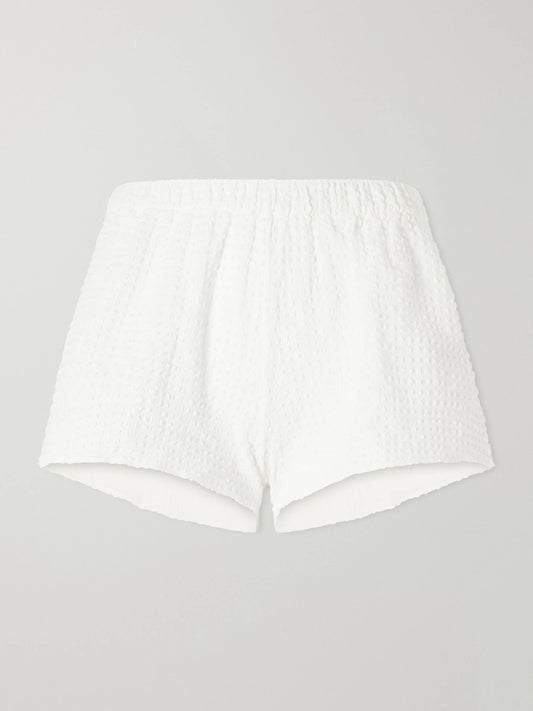 Image of a model wearing Shorts. Product name - Runner Original Crinkle Shorts in White colour by brand - Hunza G
