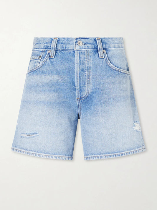 Image of a model wearing Shorts. Product name - Billie Distressed Organic Denim Shorts in Light denim colour by brand - Citizens of Humanity