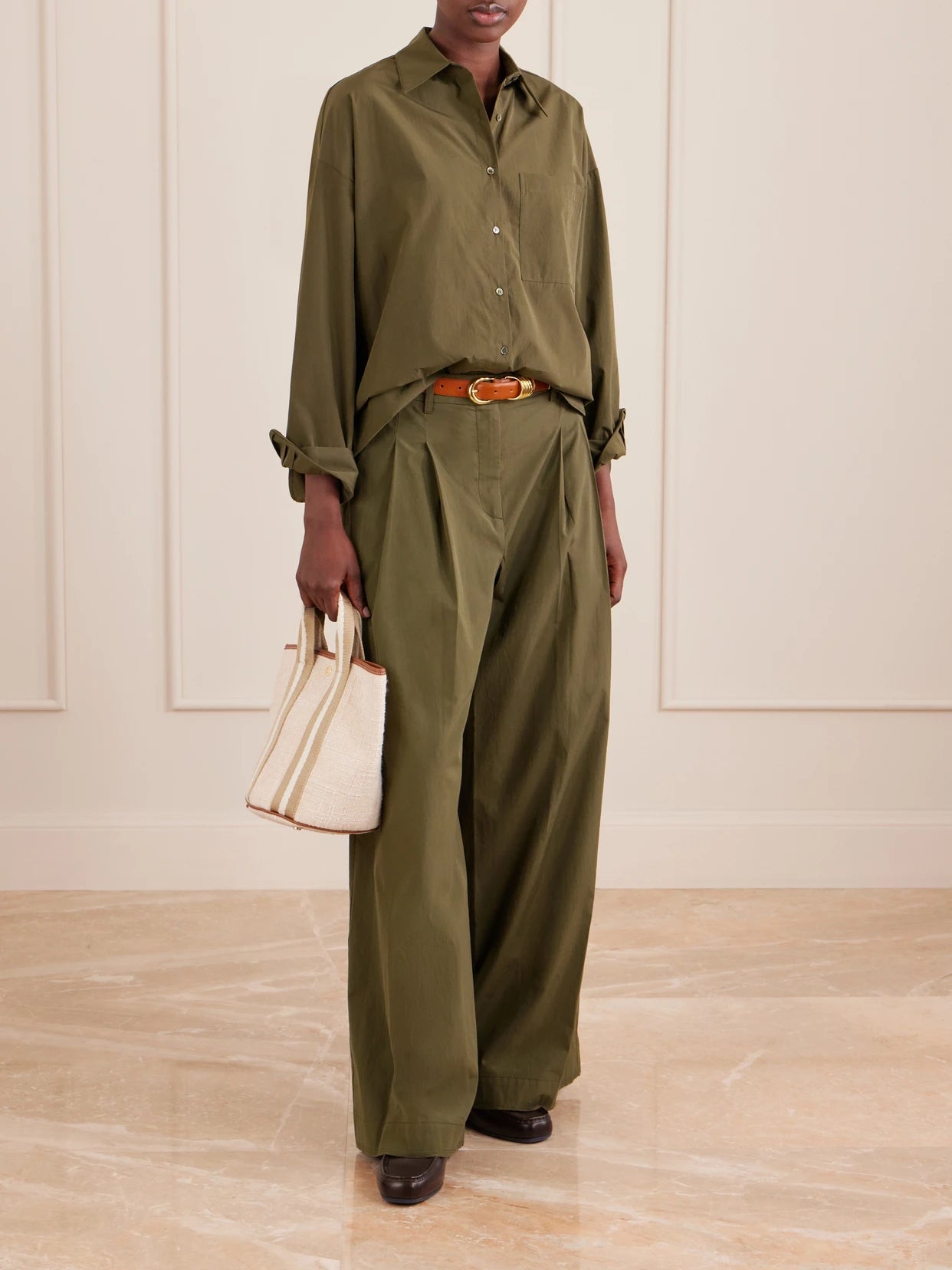 Image of a model wearing Tops. Product name - Something Borrowed Cotton Shirt in Green colour by brand - TWP