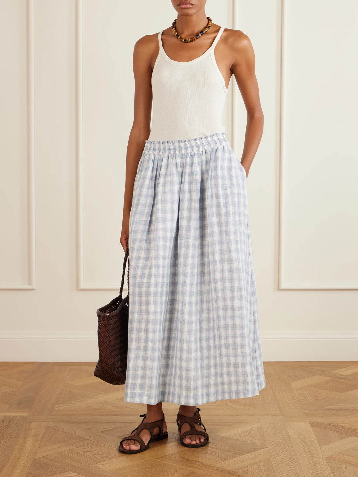 Image of a model wearing Skirts. Product name - Pleated Checked Linen Midi Skirt in Purple colour by brand - SKALL