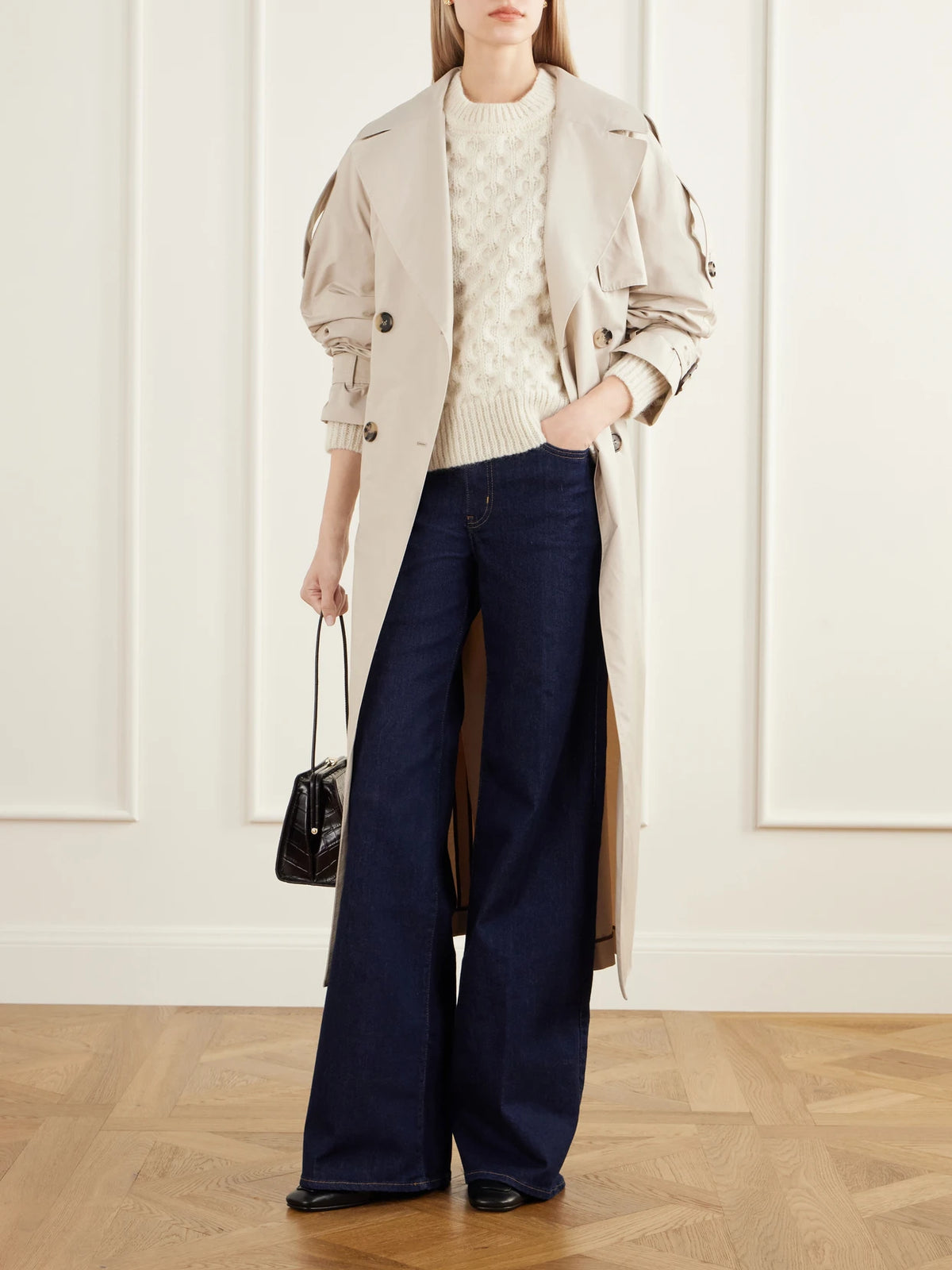 Image of a model wearing Outerwear. Product name - Lennox Cable-knit Wool Sweater in Off-white colour by brand - SKALL