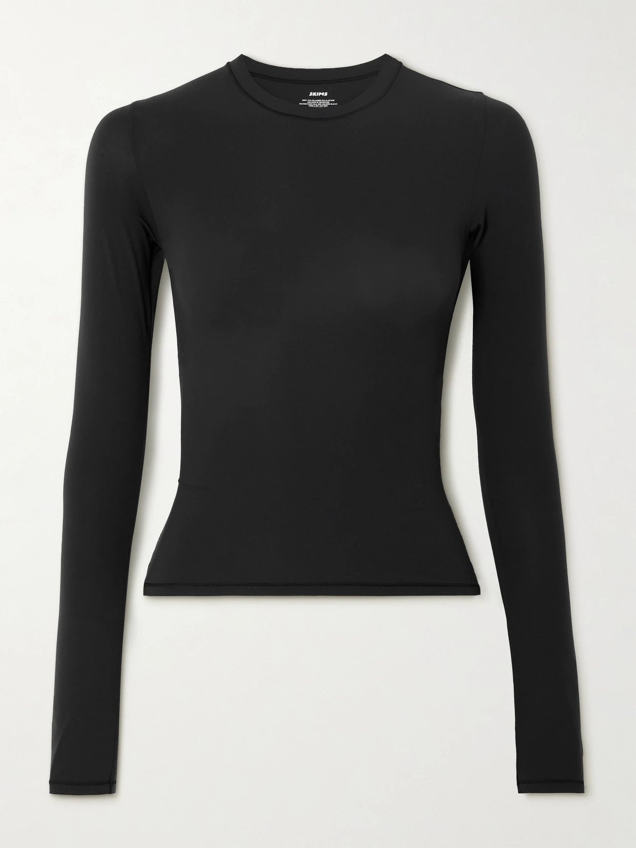 Image of a model wearing Tops. Product name - Fits Everybody Long Sleeve T-shirt - Onyx in Black colour by brand - SKIMS