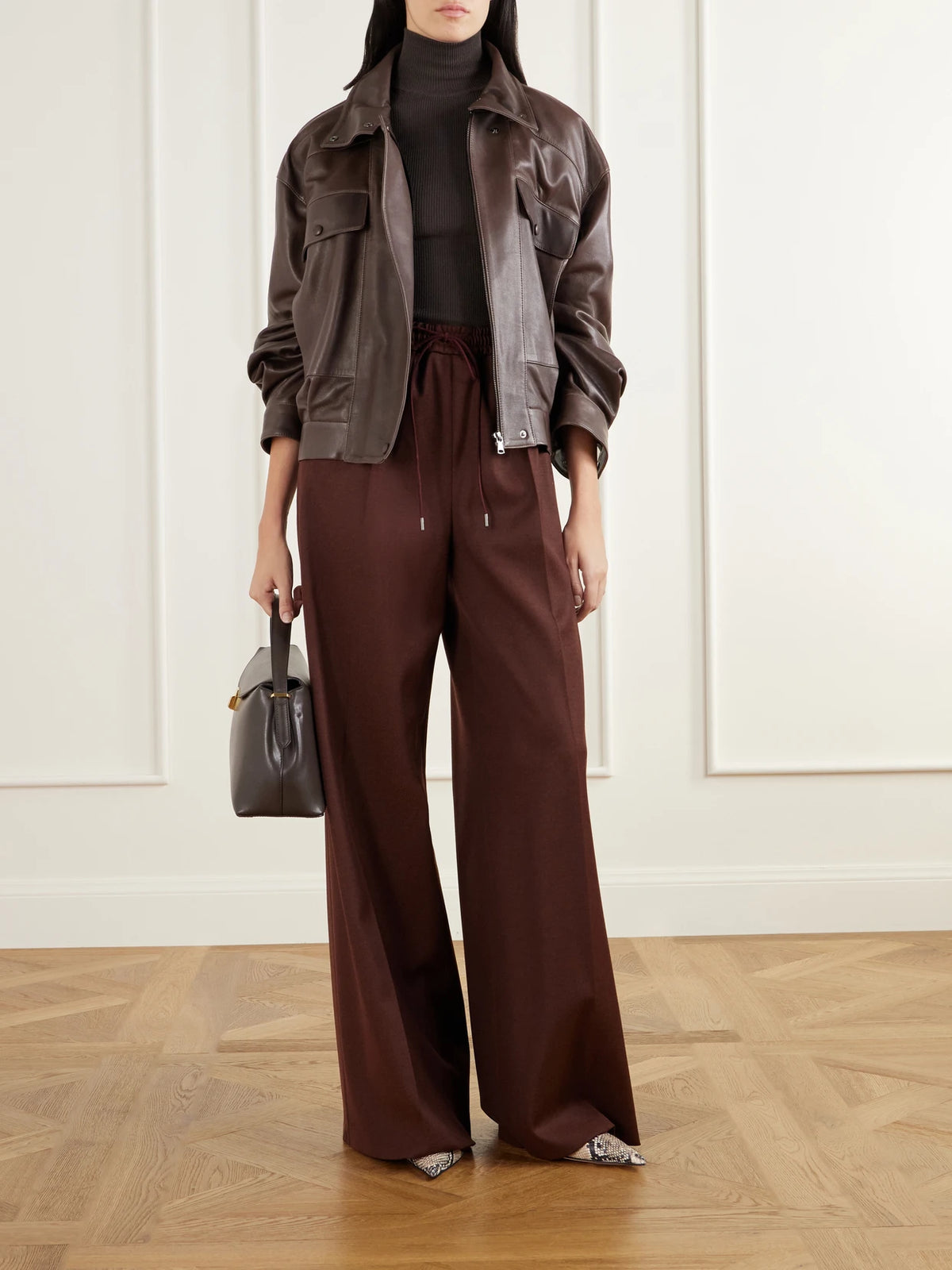 Image of a model wearing Pants. Product name - Slalom Wool-twill Wide-leg Pants in Burgundy colour by brand - Max Mara