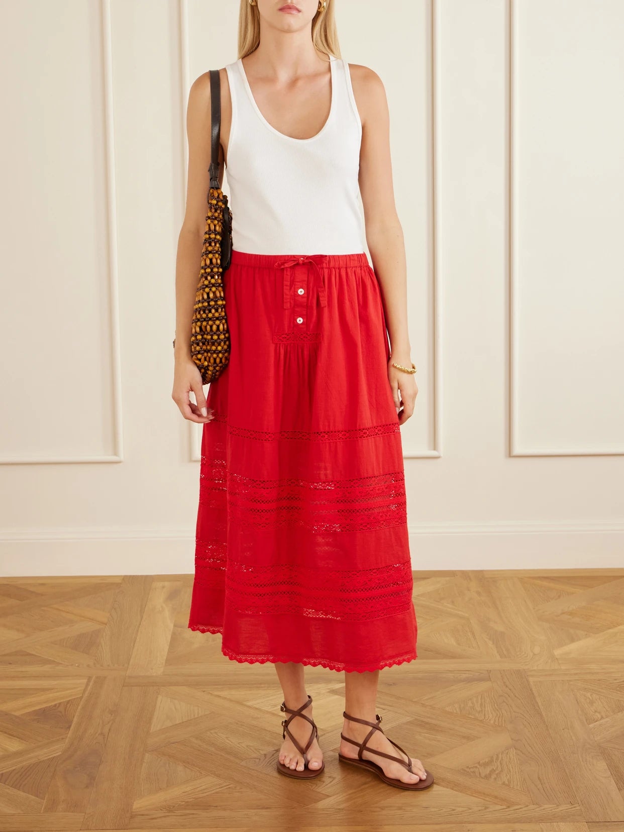 Image of a model wearing Skirts. Product name - Pippa Lace-trimmed Cotton Midi Skirt in Red colour by brand - Sea