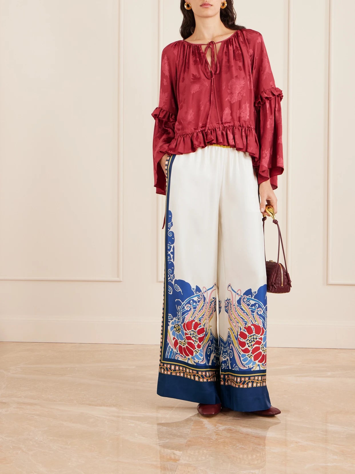 Image of a model wearing Pants. Product name - Printed Silk-twill Wide-leg Pants in Cream colour by brand - La DoubleJ