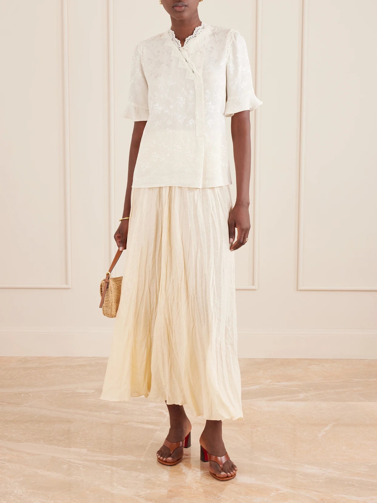 Image of a model wearing Tops. Product name - Margarita Mesh And Crochet-trimmed Floral-jacquard Silk-crepe Blouse in Ivory colour by brand - MAISON MAYLE