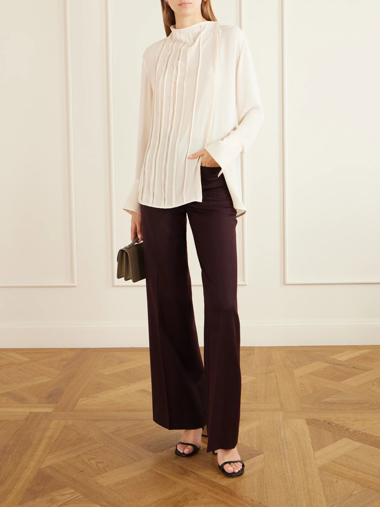 Image of a model wearing Tops. Product name - Pleated Georgette Blouse in Cream colour by brand - Victoria Beckham