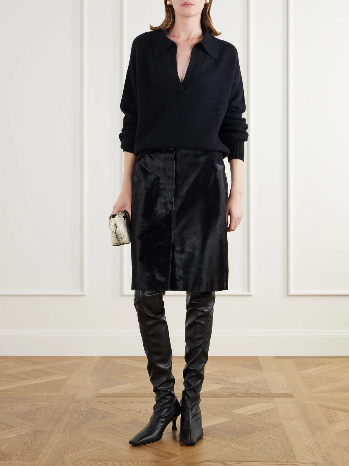 Image of a model wearing Outerwear. Product name - Kaia Cashmere Polo Sweater in Black colour by brand - Almada