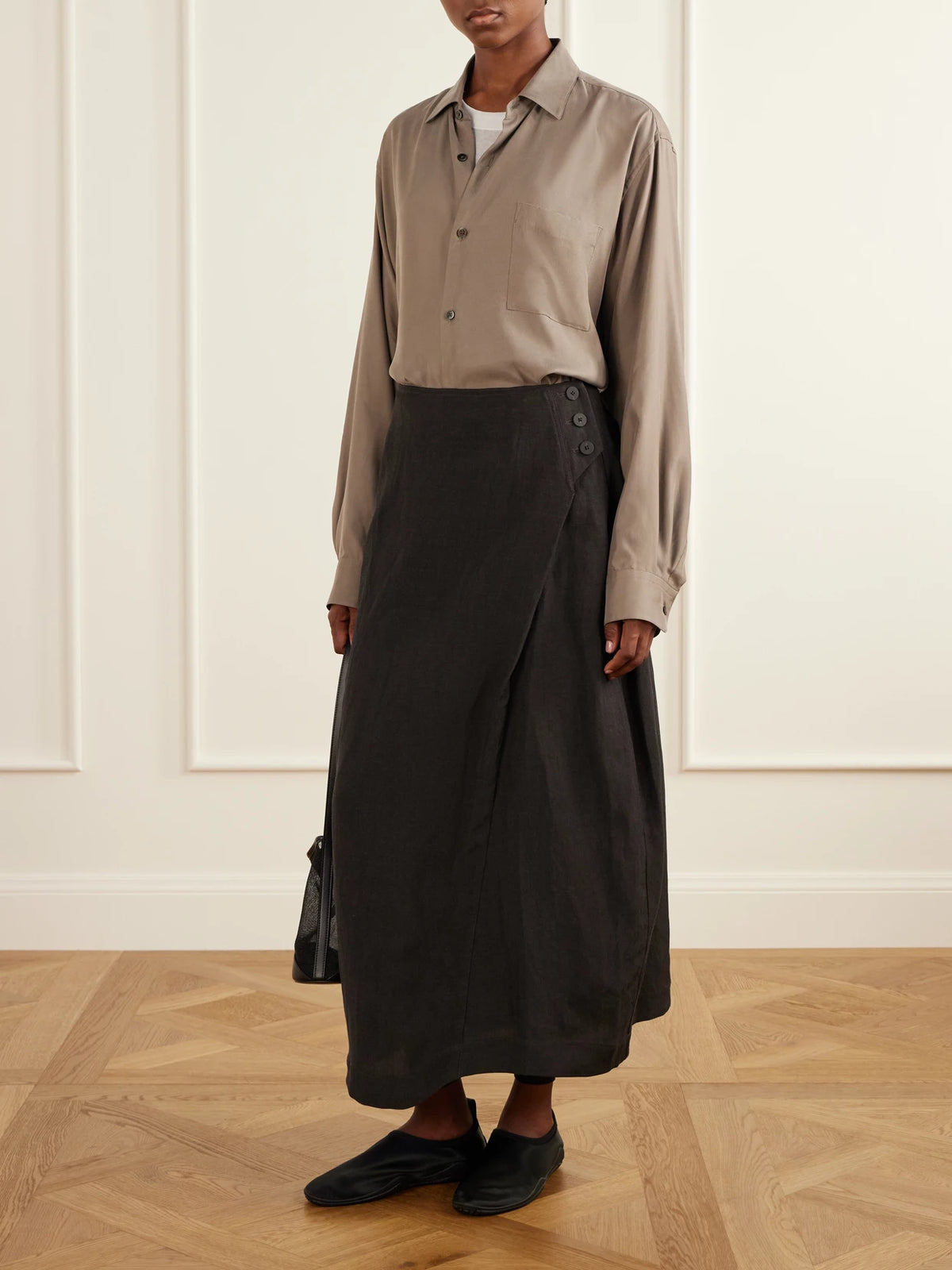 Image of a model wearing Skirts. Product name - Pleated Woven Midi Skirt in Dark gray colour by brand - Studio Nicholson