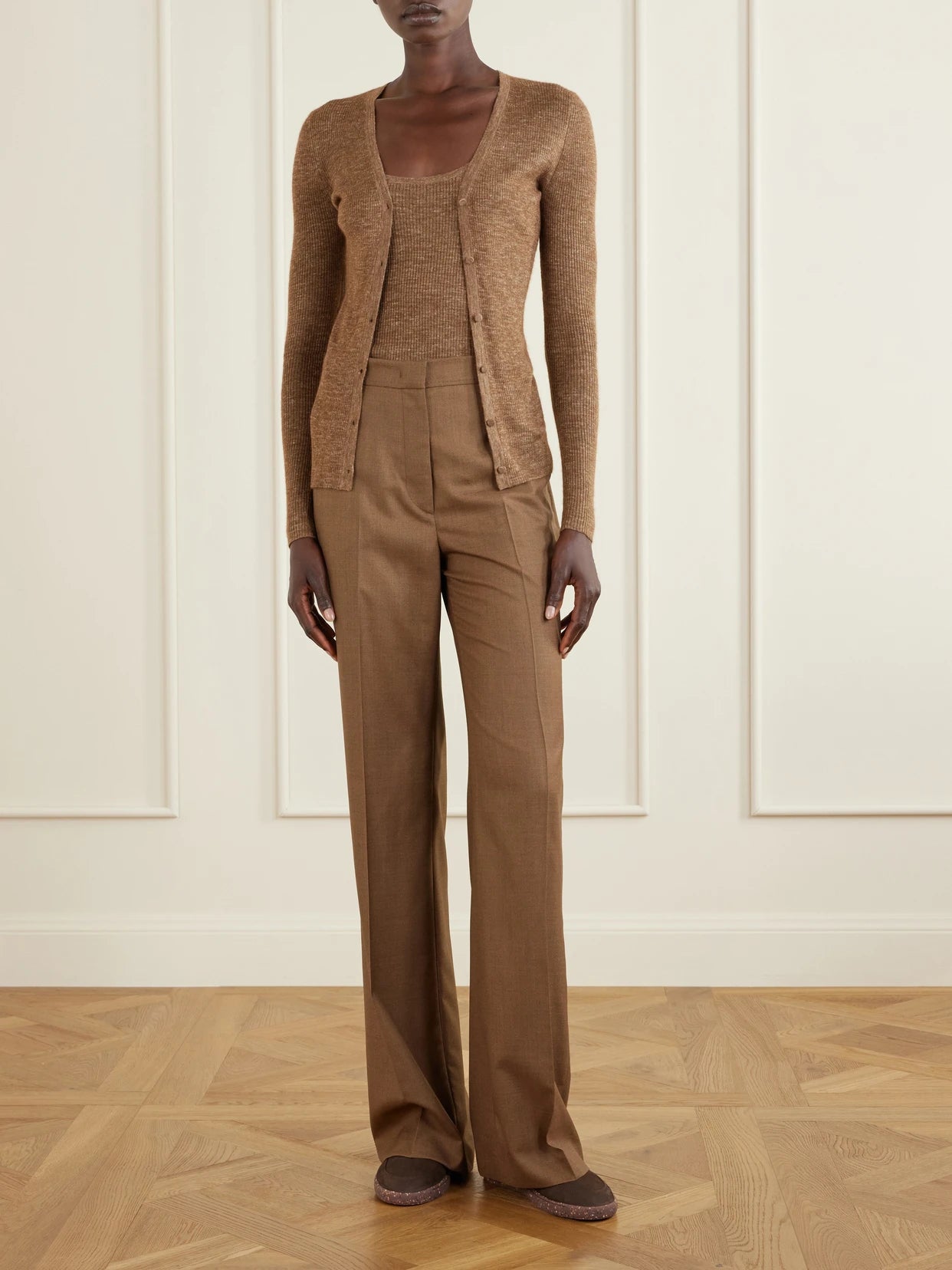 Image of a model wearing Outerwear. Product name - Cinxia Ribbed Cashmere, Silk And Hemp-blend Tank in Brown colour by brand - Gabriela Hearst