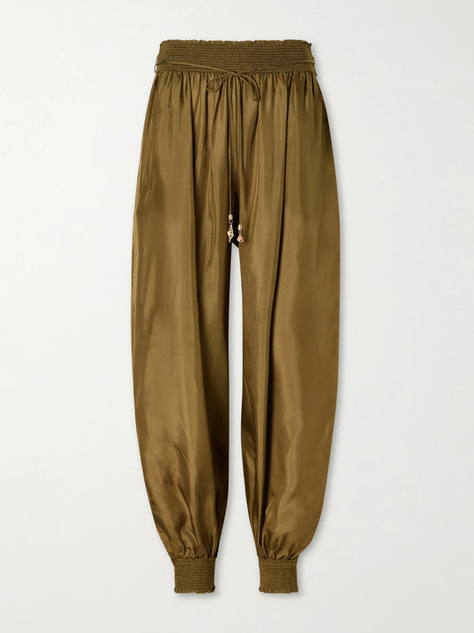 Image of a model wearing Pants. Product name - Mahon Silk Balloon Pants in Green colour by brand - Zimmermann