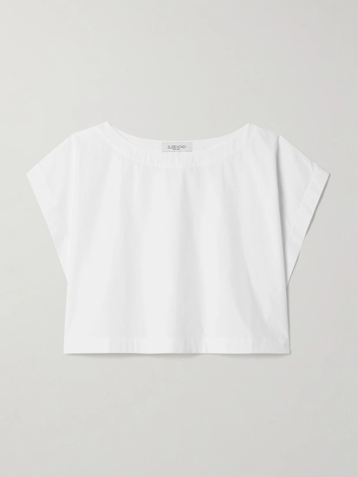 Image of a model wearing Tops. Product name - Kori Cropped Cotton-poplin Top in White colour by brand - Suzie Kondi