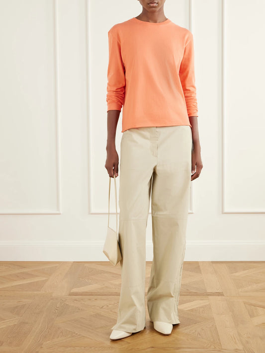 Image of a model wearing Tops. Product name - Cotton And Cashmere-blend T-shirt in Orange colour by brand - Auralee