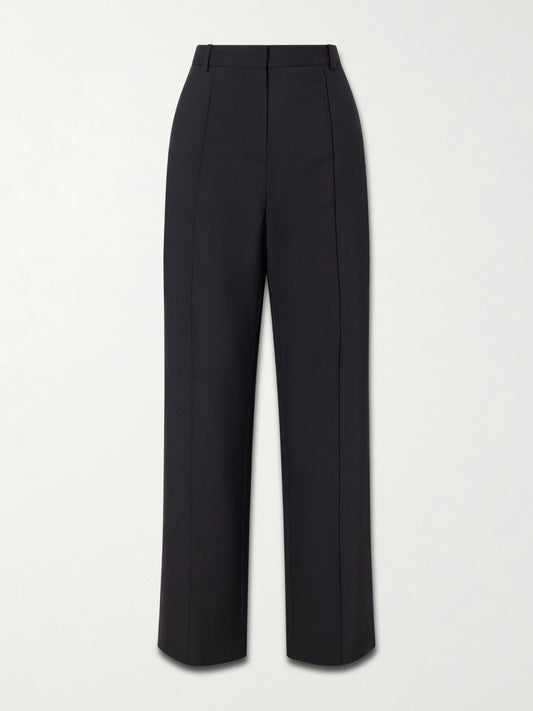 Image of a model wearing Pants. Product name - Pleated Pinstriped Woven Wide-leg Pants in Black colour by brand - ST. AGNI