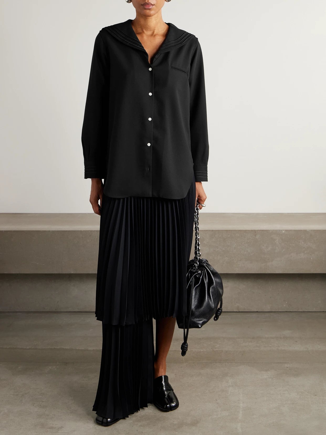 Image of a model wearing Tops. Product name - Astor Wool-crepe Blouse in Black colour by brand - BODE