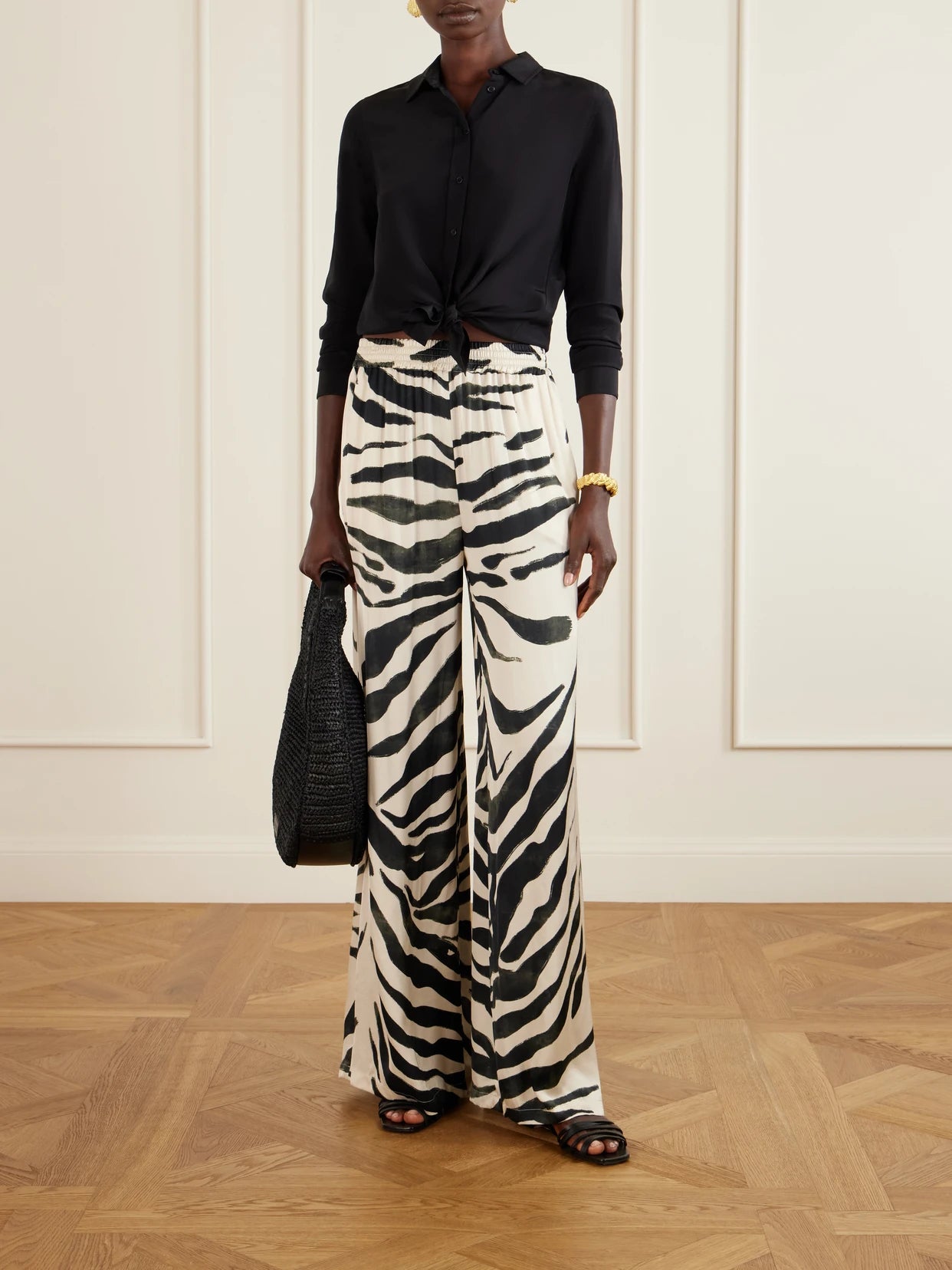 Image of a model wearing Pants. Product name - Tamu Mia Printed Satin Wide-leg Pants in White colour by brand - Andres Otalora