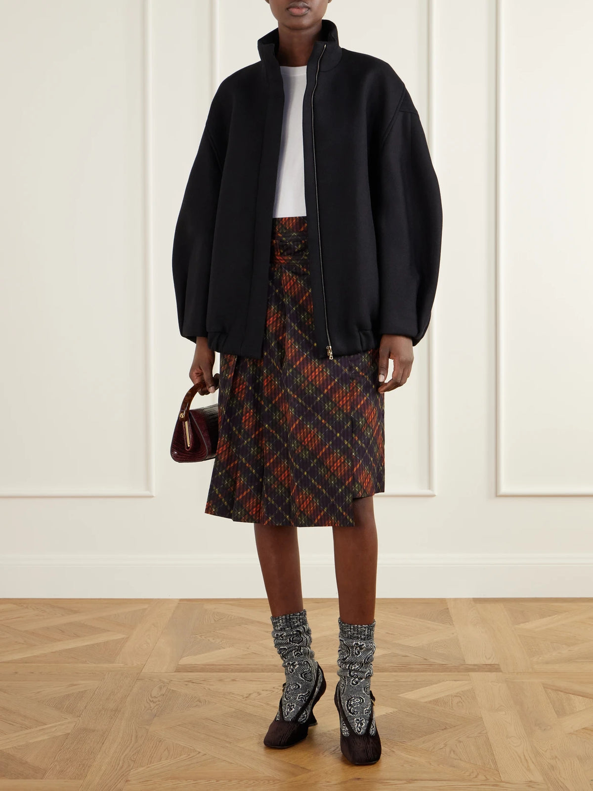 Image of a model wearing Skirts. Product name - Checked Pleated Cotton Midi Skirt in Multi colour by brand - Dries Van Noten