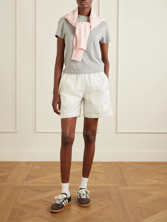 Image of a model wearing Shorts. Product name - + Wales Bonner Embroidered Shell Shorts in White colour by brand - adidas Originals