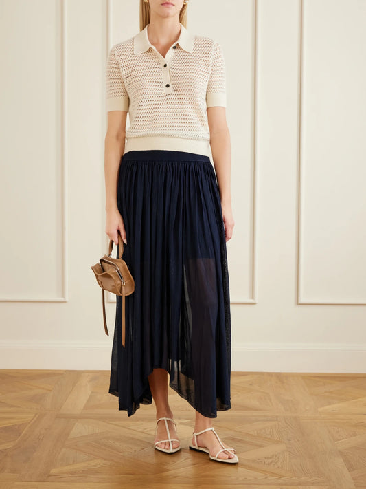 Image of a model wearing Skirts. Product name - Asymmetrical Plissé Midi Skirt in Navy colour by brand - Maria McManus