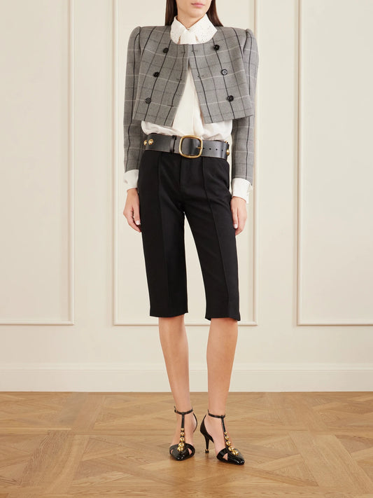 Image of a model wearing Pants. Product name - Buckle-embellished Wool-crepe Straight-leg Capri Pants in Black colour by brand - Chloé
